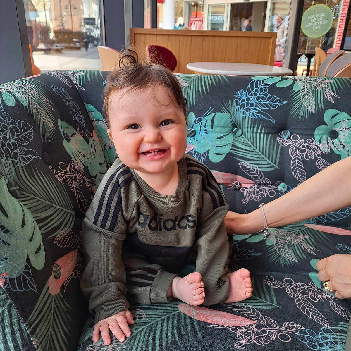 Noah joined the competition — help win amazing prizes! adidas, baby, child, clothing, couch, cute, floral_pattern, foot, hair, hand, happy, indoor, interior, light, person, seated, smiling, support, tooth, window