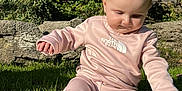 Scarlett is registered to the contest to win money with this photo: baby, clothing, crawling, face, grass, head, hosiery, nature, outdoors, pants, park, person, photography, plant, portrait, rock, sitting, sock, vegetation, yard