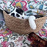 cat, kitten, black_and_white, basket, woven_basket, floral, fabric, blanket, paw, whiskers, eyes, pet, animal, cute, indoors, resting, lounging, portrait, home_decor, colorful