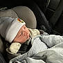 baby, car_seat, blanket, hat, sleeping, infant, child, clothing, seatbelt, comfort, indoor, transportation, car_interior, safety, young_child, cute, bundle, resting, cozy, newborn