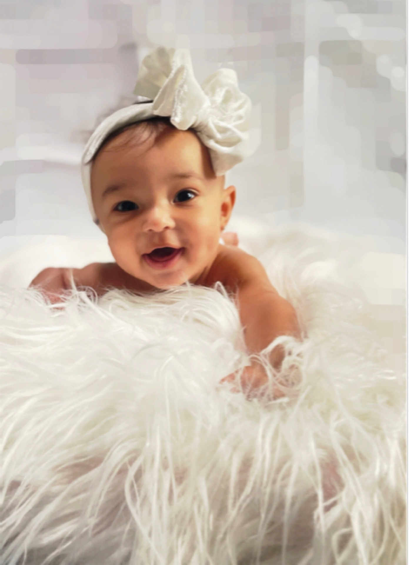 Irie joined the competition — help win amazing prizes! baby, child, headband, white_bow, smiling, happy, fluffy_blanket, soft_texture, portrait, cute, infant, reaching_hand, closeup, indoors, soft_light, skin, face, expression, young, adorable