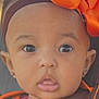 Irie is registered to the contest to win money with this photo: baby, child, face, headband, orange_bow, brown_clothing, portrait, closeup, cute, eyes, expression, young, adorable, infant, person, fashion, earrings, skin, tongue, head
