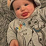 baby, child, hoodie, tongue_out, cute, clothing, cartoon, dog, grey, smiling, face, infant, apparel, sleeve, hand, person, playful, young, portrait, fabric