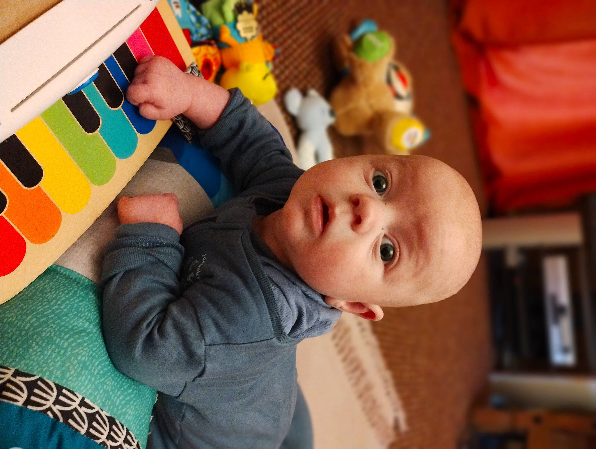 George is registered to the contest to win money with this photo: baby, baby_playing_with_toys, baby_products, baby_toddler_clothing, baby_toys, bookcase, child, fun, happy, leisure, person, play, room, shelf, sitting, toddler, toy, tree, wood, yellow
