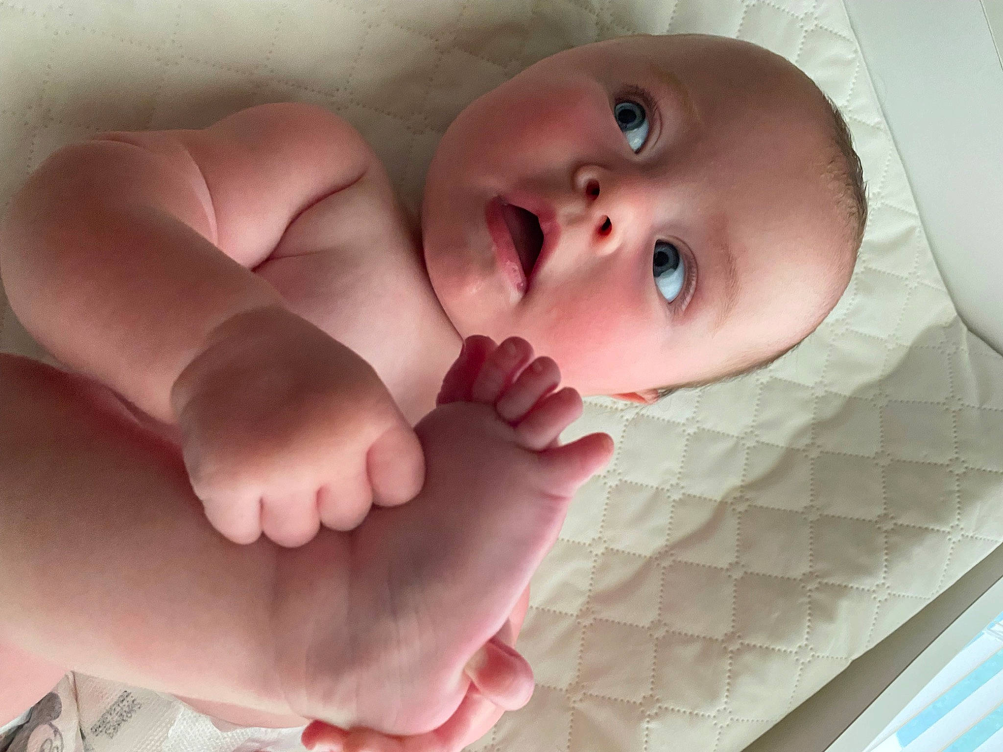 Cayson is registered to the contest to win money with this photo: arm, baby, barefoot, cheek, child, close_up, comfort, eyelash, face, finger, foot, gesture, head, human_body, human_leg, nail, person, pink, skin, surprise