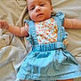 arms_outstretched, baby, bed_sheet, calm_expression, child, colorful_clothing, cute, denim_skirt, eyes, face, head, human, indoors, infant, lying_down, portrait, skin, small_feet, small_hands, soft_texture