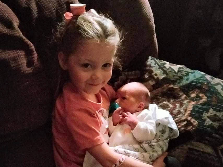 Lillyann is registered to the contest to win money with this photo: baby, baby_toddler_clothing, cheek, child, comfort, couch, ear, event, fun, happy, iris, joy, lap, mammal, mouth, nose, person, sitting, skin, smile