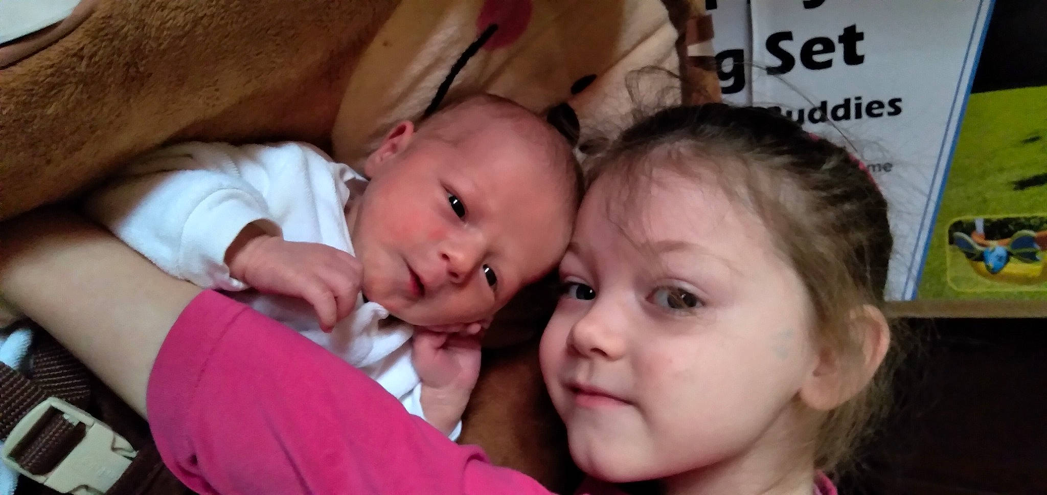 Lillyann is registered to the contest to win money with this photo: baby, baby_toddler_clothing, cheek, child, comfort, couch, ear, event, eyebrow, eyelash, fun, gesture, happy, lip, mouth, nose, person, sitting, skin, smile