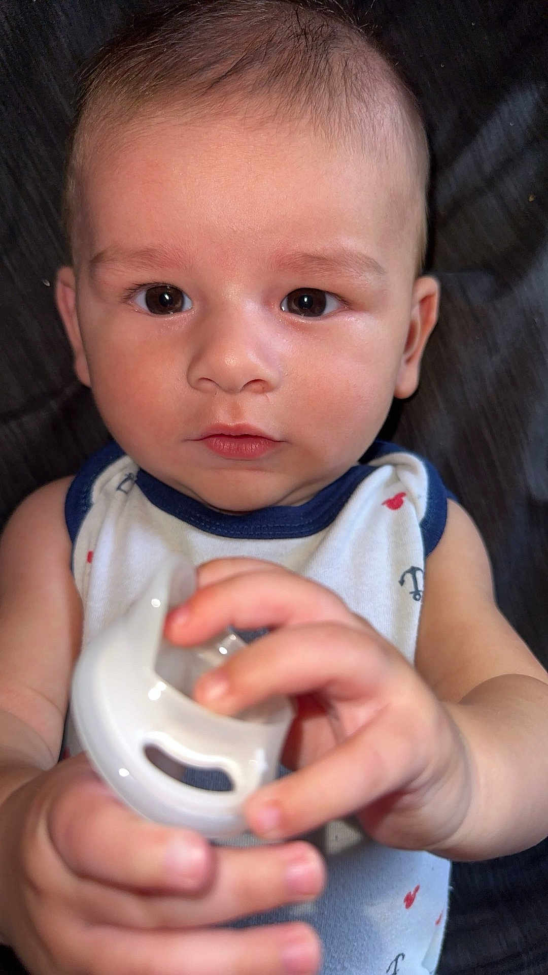 Bobby joined the competition — help win amazing prizes! baby, infant, child, pacifier, hand, face, eyes, skin, clothing, sleeveless, curious, cute, portrait, indoors, closeup, expression, young, person, fingernails, background