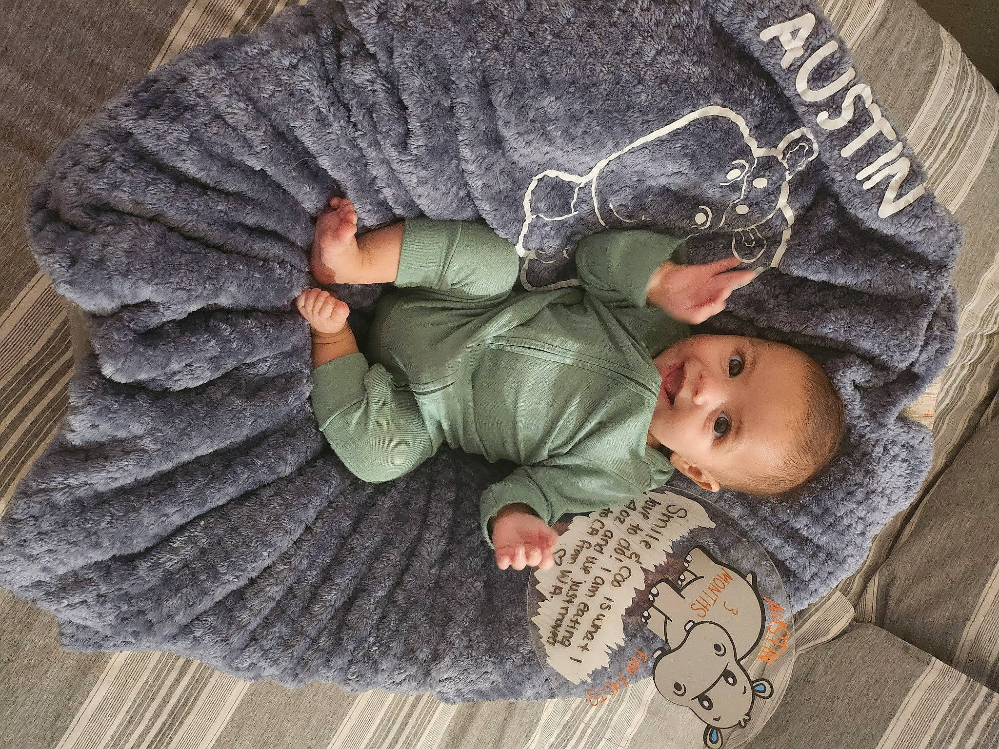 Austin joined the competition — help win amazing prizes! baby, baby_products, baby_toddler_clothing, camouflage, child, comfort, flooring, gesture, grey, linens, military_camouflage, pattern, person, sitting, sleep, sleeve, soldier, toddler, tree, wood