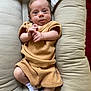 Theodore joined the competition — help win amazing prizes! baby, infant, child, person, cushion, clothing, sock, white_sock, beige_outfit, indoor, portrait, cute, small_hands, wide_eyes, soft_fabric, relaxed, lying_down, skin, head, face