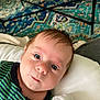 Theodore is registered to the contest to win money with this photo: baby, infant, face, eyes, hair, pillow, striped_clothing, blue_eyes, curious_expression, indoor, carpet, table, person, closeup, portrait, newborn, skin, child, cute, lying_down