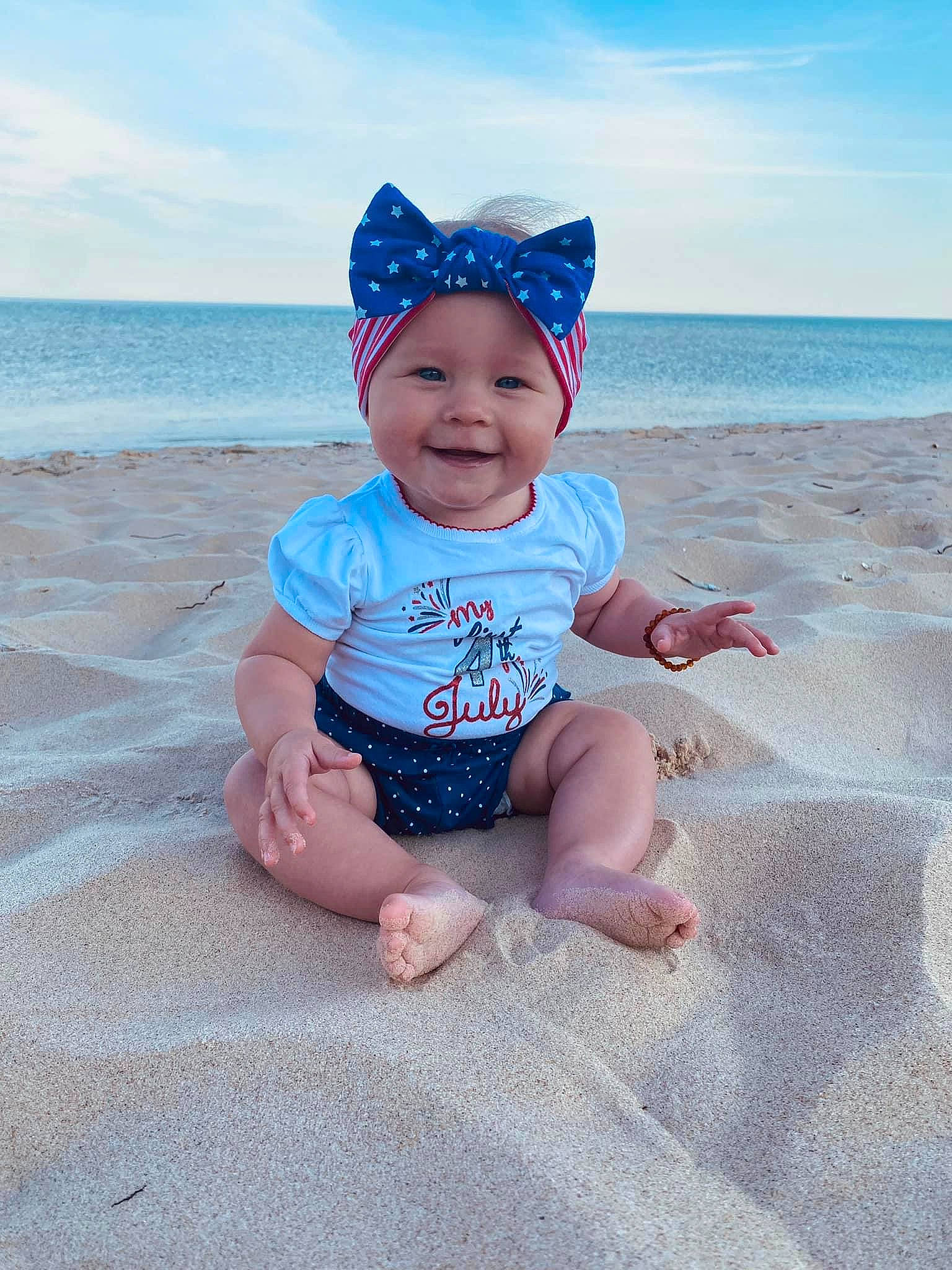 Willow joined the competition — help win amazing prizes! azure, baby, baby_toddler_clothing, beach, blue, cloud, face, fun, happy, hat, headwear, joy, morning, person, pink, sky, sleeve, smile, standing, sunlight