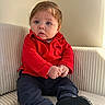 Isaïe a rejoint le concours — aidez-le/la à gagner de superbes lots ! armchair, baby, black_shoes, blue_eyes, boss_logo, child, closeup, cozy, cute_expression, hands, indoor, infant, light_brown_hair, navy_pants, portrait, red_polo, ribbed_sofa, sitting, soft_light, sunlight
