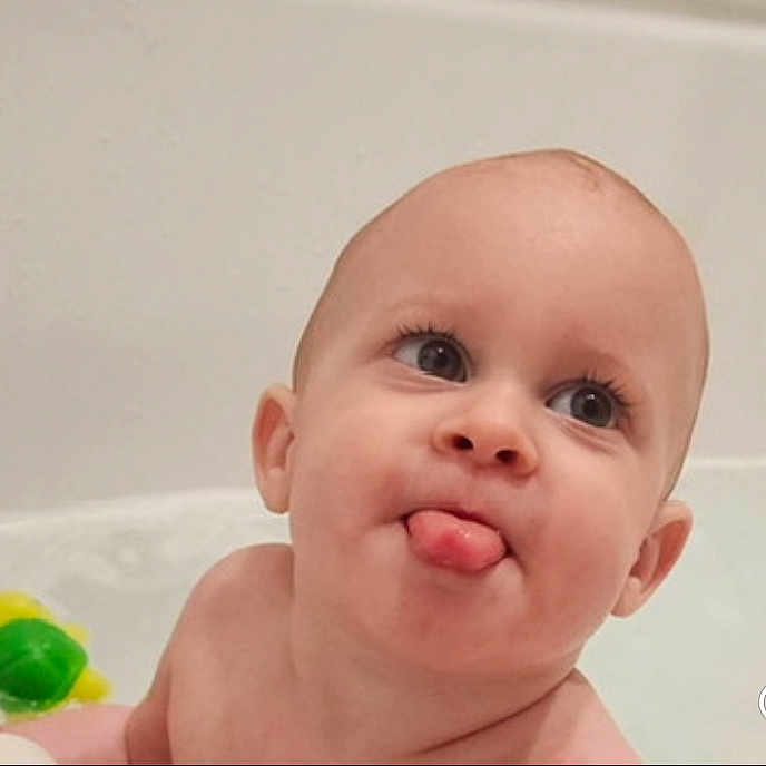 Kyson is registered to the contest to win money with this photo: baby, bath, bath_time, bathtub, child, closeup, cute, expression, face, happy, head, indoor, infant, mischievous, person, playful, skin, tongue_out, toy, water