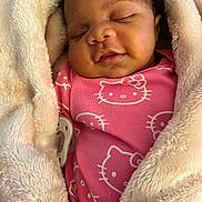 Layla joined the competition — help win amazing prizes! baby, sleeping, blanket, pacifier, pink_clothing, hello_kitty, infant, soft_texture, closeup, cozy, cute, child, wrapped, warm, resting, indoors, person, face, newborn, portrait
