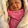 baby, sleeping, blanket, pacifier, pink_clothing, hello_kitty, infant, soft_texture, closeup, cozy, cute, child, wrapped, warm, resting, indoors, person, face, newborn, portrait