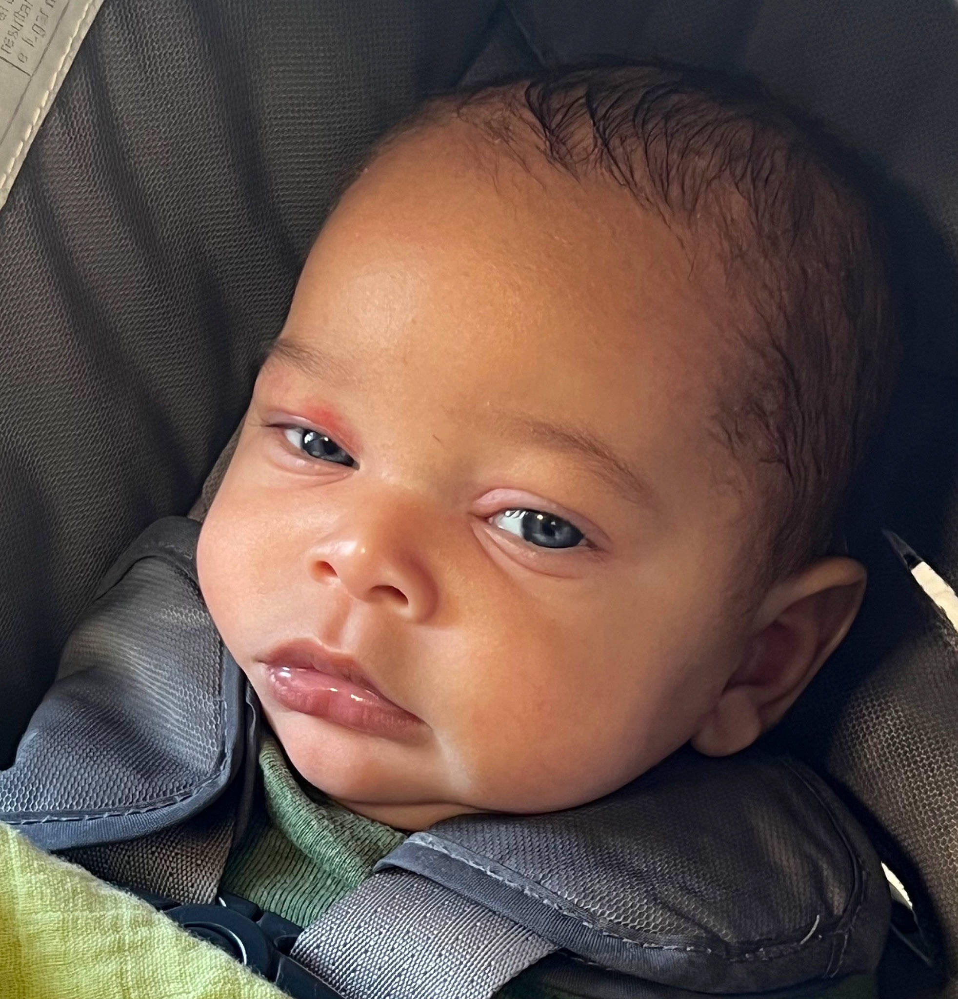 Michael is registered to the contest to win money with this photo: baby, baby_toddler_clothing, car_seat, cheek, child, clothing, collar, comfort, ear, eyebrow, eyelash, flash_photography, iris, lip, nose, outerwear, person, skin, sleeve, smile