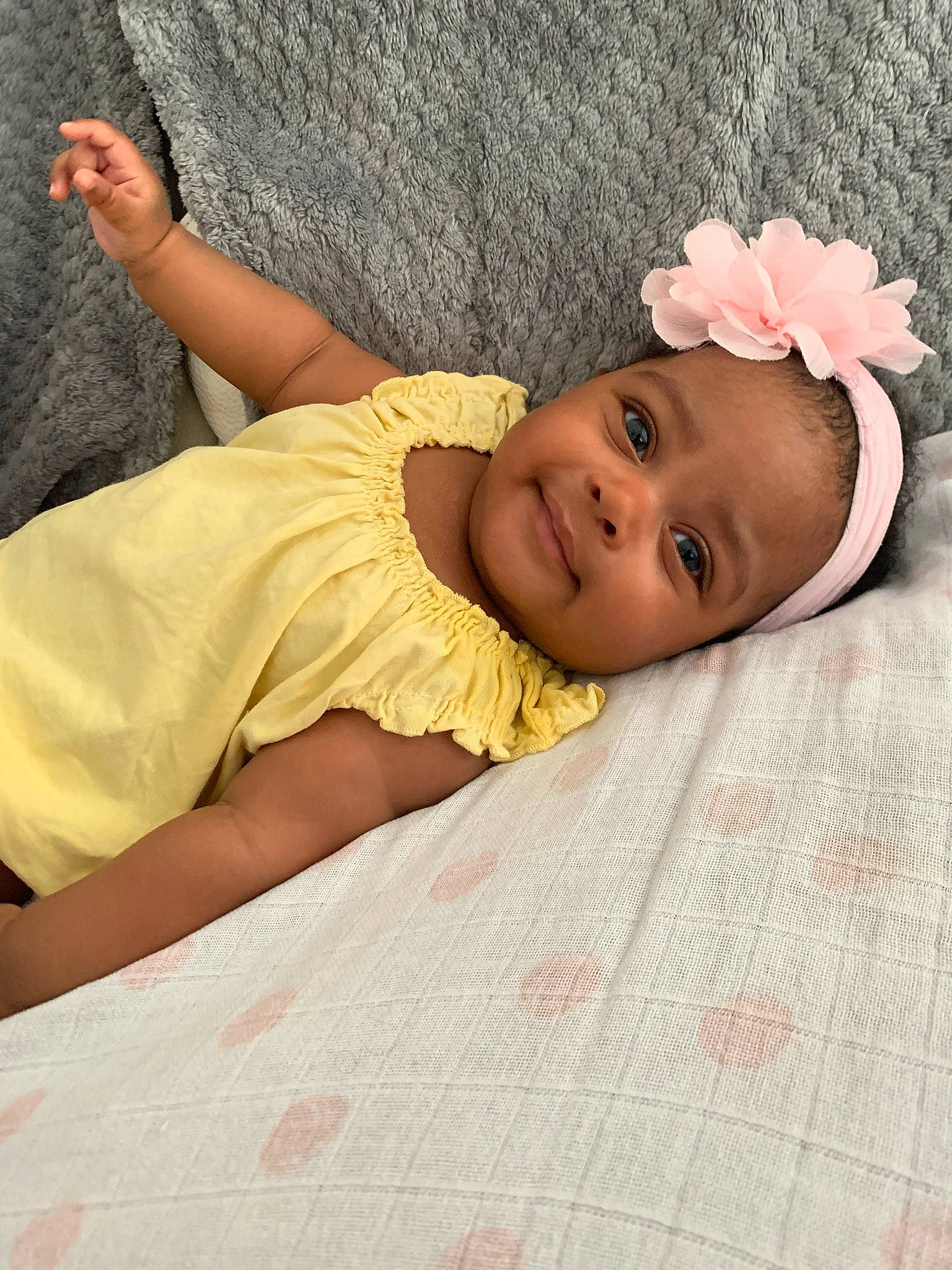 Inayah participe au concours pour gagner de l'argent avec cette photo : baby, baby_products, baby_toddler_clothing, bedding, child, comfort, dress, grass, happy, headgear, joy, linens, lip, person, petal, pink, skin, sleeve, smile, textile