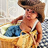 toddler, child, hat, wicker_basket, blue_jeans, suspenders, indoor, blanket, expression, large_eyes, basket, clothing, person, cute, sitting, portrait, face, baby, hat_brim, curious_look