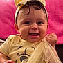 baby, child, smiling, yellow_outfit, headband, tulle, fabric, pink_background, happy, cute, portrait, indoor, person, infant, clothing, cheerful, toddler, face, hands, sitting