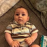 Elias is registered to the contest to win money with this photo: baby, infant, diaper, striped_shirt, couch, blanket, baby_wipes, furniture, indoors, person, cute, child, relaxed, clothing, soft_texture, small_hands, young, lying_down, curious, casual