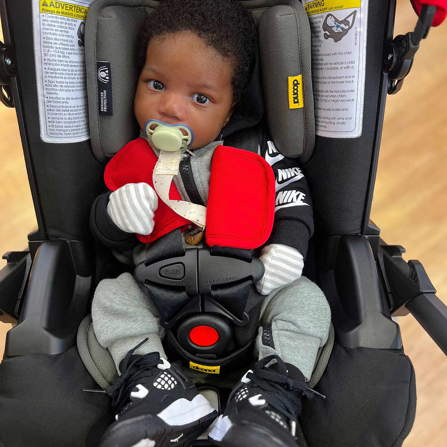 Ahmir is registered to the contest to win money with this photo: baby, bodypart, car, clothing, coat, face, finger, footwear, glove, hand, head, jacket, person, photography, portrait, shoe, sitting, sneaker, transportation, vehicle
