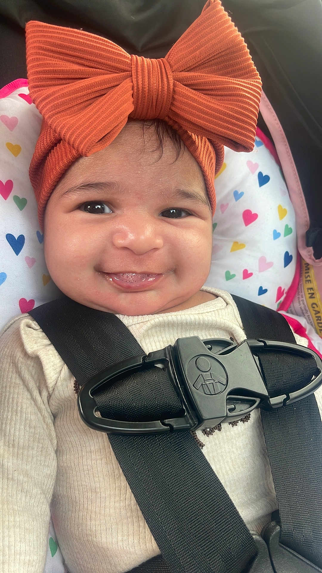 Nicolle joined the competition — help win amazing prizes! baby, child, smiling, car_seat, headband, bow, straps, safety, infant, cute, happy, clothing, pattern, heart, seat, seatbelt, closeup, portrait, indoors, baby_girl