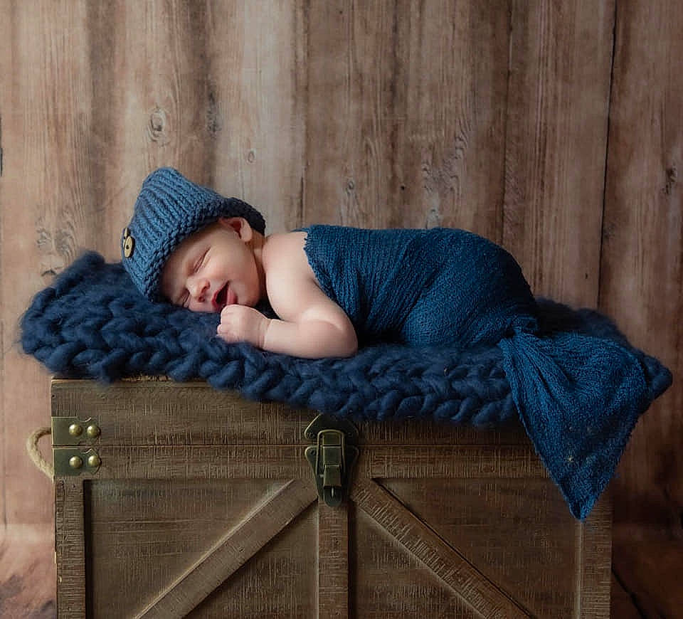 Scott is registered to the contest to win money with this photo: baby, beanie, cap, child, headgear, headwear, nap, person, photography, sitting