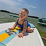 Aliyah Olivia is registered to the contest to win money with this photo: baby, child, paddleboard, water, lake, outdoor, summer, blue_sky, sunlight, swimsuit, sitting, portrait, face, person, floating, recreation, nature, shoreline, inflatable_boat, happy
