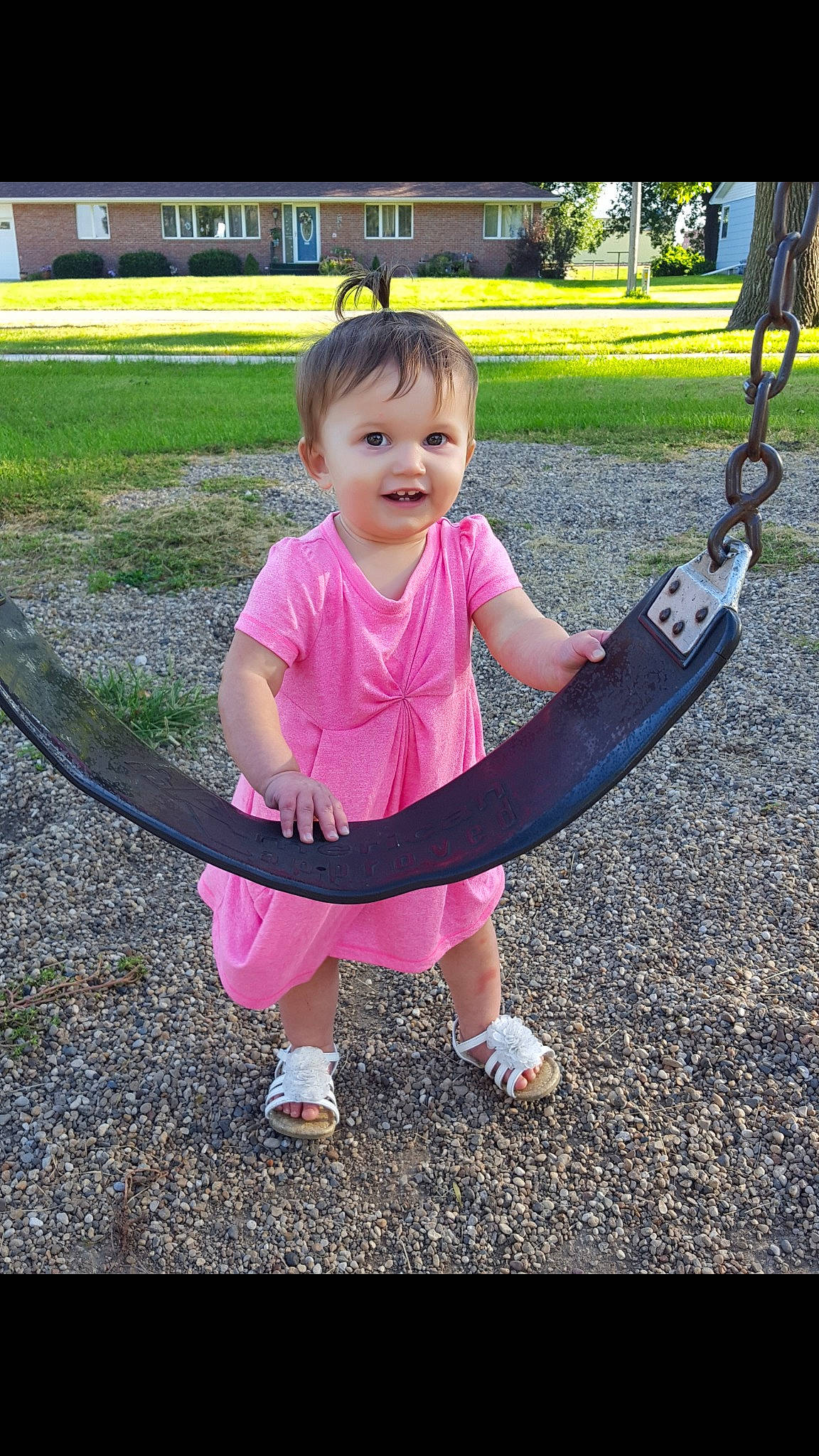 Maddelyn joined the competition — help win amazing prizes! child, day, facial_expression, fun, girl, grass, happiness, leisure, outdoor_play_equipment, person, pink, plant, play, playground, recreation, red, sitting, smile, summer, toddler