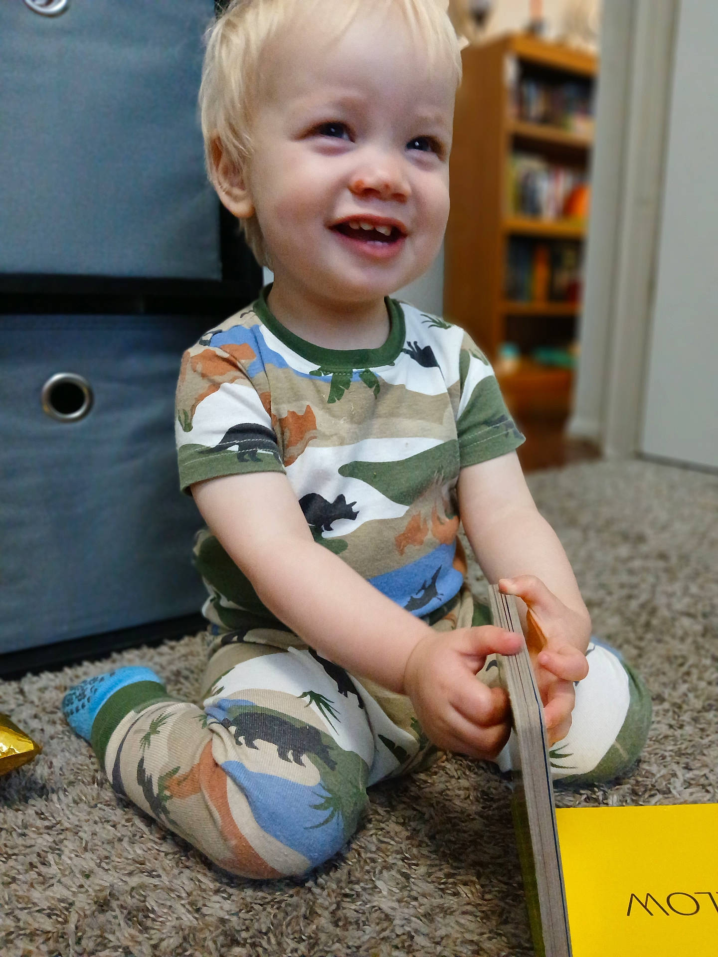 Orion is registered to the contest to win money with this photo: baby, clothing, couch, cutlery, face, footwear, furniture, head, pants, person, photography, portrait, shelf, shoe, shorts, sitting, spoon, sword, t_shirt, weapon