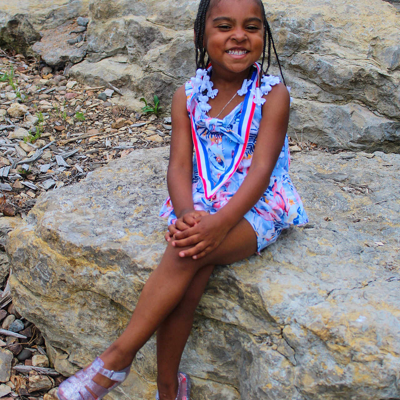 Aveah is registered to the contest to win money with this photo: bodypart, child, clothing, dress, face, female, finger, footwear, girl, gravel, happy, head, person, road, rock, rubble, shoe, sitting, slate, smile