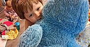 Beckett joined the competition — help win amazing prizes! child, toddler, baby, siblings, teddy_bear, stuffed_animal, blue, hugging, playroom, toys, smiling, portrait, indoor, home, messy_room, floor, baby_doll, clothing, family, cuddling