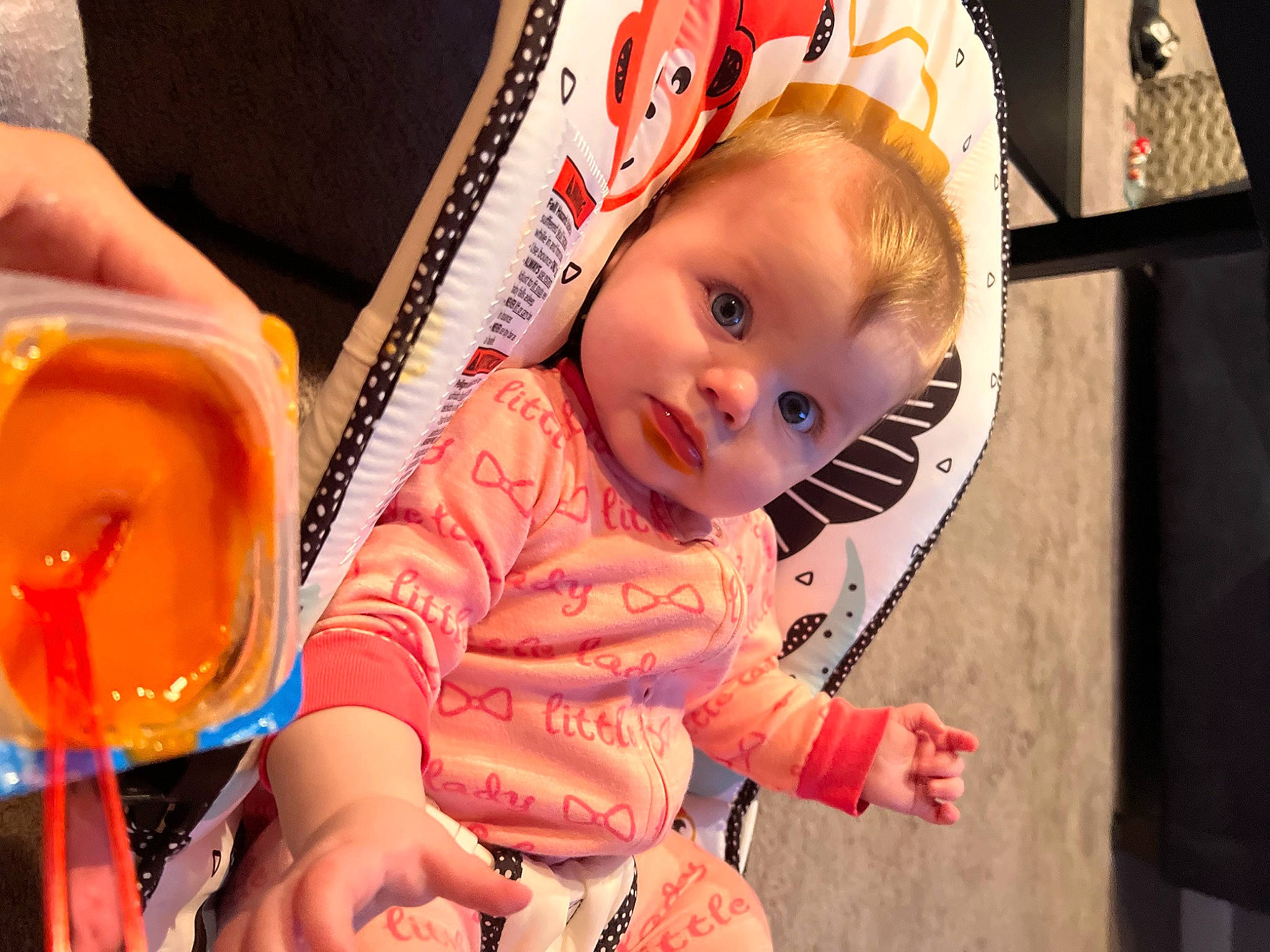 Hailey is registered to the contest to win money with this photo: baby, baby_products, baby_toddler_clothing, birthday, chair, cheek, child, event, fashion_accessory, fun, happy, orange, party, person, pink, sitting, skin, sweetness, tableware, toddler