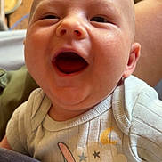 Dean joined the competition — help win amazing prizes! baby, infant, child, face, portrait, yawning, open_mouth, smiling, eyes, bald, onesie, clothing, cartoon, stars, moon, indoor, wooden_floor, candid, close_up, happy