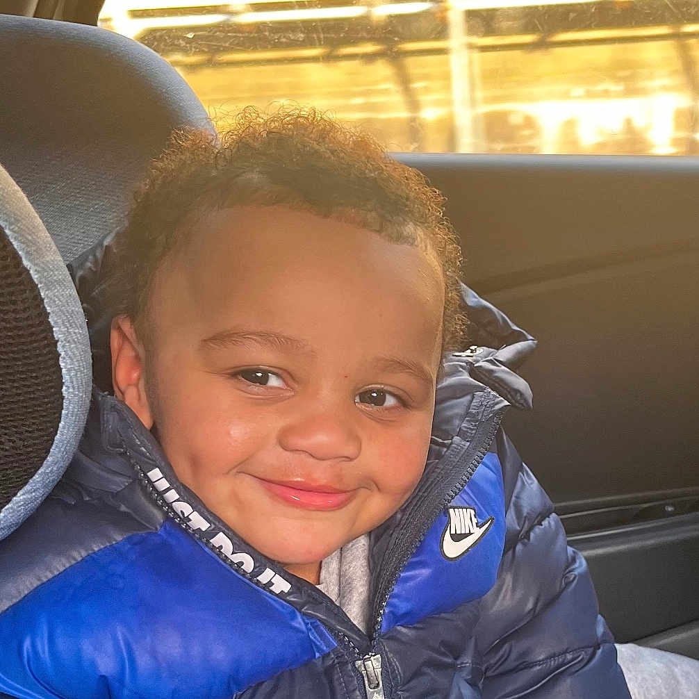 Abdul joined the competition — help win amazing prizes! baby, bodypart, clothing, coat, cushion, face, glove, happy, head, homedecor, jacket, lifejacket, mouth, pants, person, photography, portrait, smile, teeth, vest