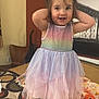 Raelynn is registered to the contest to win money with this photo: toddler, child, dress, rainbow, tutu, barefoot, bedspread, pattern, flower_hair_accessory, smiling, standing, indoor, furniture, chair, vacuum, photograph, black_and_white, bridge, happy, cute