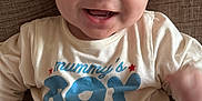 Joseph participe au concours pour gagner de l'argent avec cette photo : baby, child, smiling, face, clothing, sitting, couch, indoor, cute, portrait, happy, toddler, infant, young_child, person, apparel, text_on_clothing, mammys_boy, cozy, home