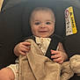 Joseph participe au concours pour gagner de l'argent avec cette photo : baby, car_seat, blanket, plush_toy, infant, smiling, child, seatbelt, cute, indoors, person, young_child, soft_toy, clothing, happy, portrait, baby_clothes, sitting, head, face