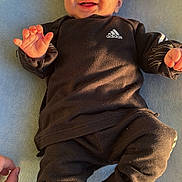 Joseph participe au concours pour gagner de l'argent avec cette photo : adidas, baby, black_clothing, blue_background, casual, child, cozy, cute, hand, happy, indoor, infant, lying_down, portrait, small_hands, smiling, socks, soft_light, toddler, towel