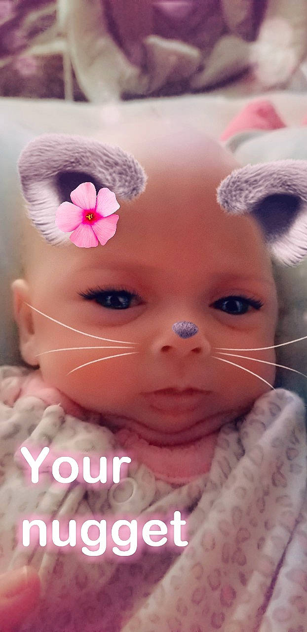 Lily joined the competition — help win amazing prizes! cheek, child, close_up, doll, eye, eyebrow, face, forehead, girl, hair_accessory, head, human_hair_color, infant, lip, nose, person, petal, pink, product, skin