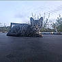 cat, kitten, tabby, animal, outdoor, trampoline, nature, sky, cloudy, bushes, pet, young, feline, resting, looking, grass, evening, quiet, calm, cute