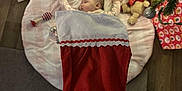 Stella is registered to the contest to win money with this photo: accessories, baby, bag, blanket, christmas, christmasdecorations, christmasstocking, christmastree, clothing, face, festival, firstaid, gift, handbag, head, hosiery, openingpresent, person, stocking