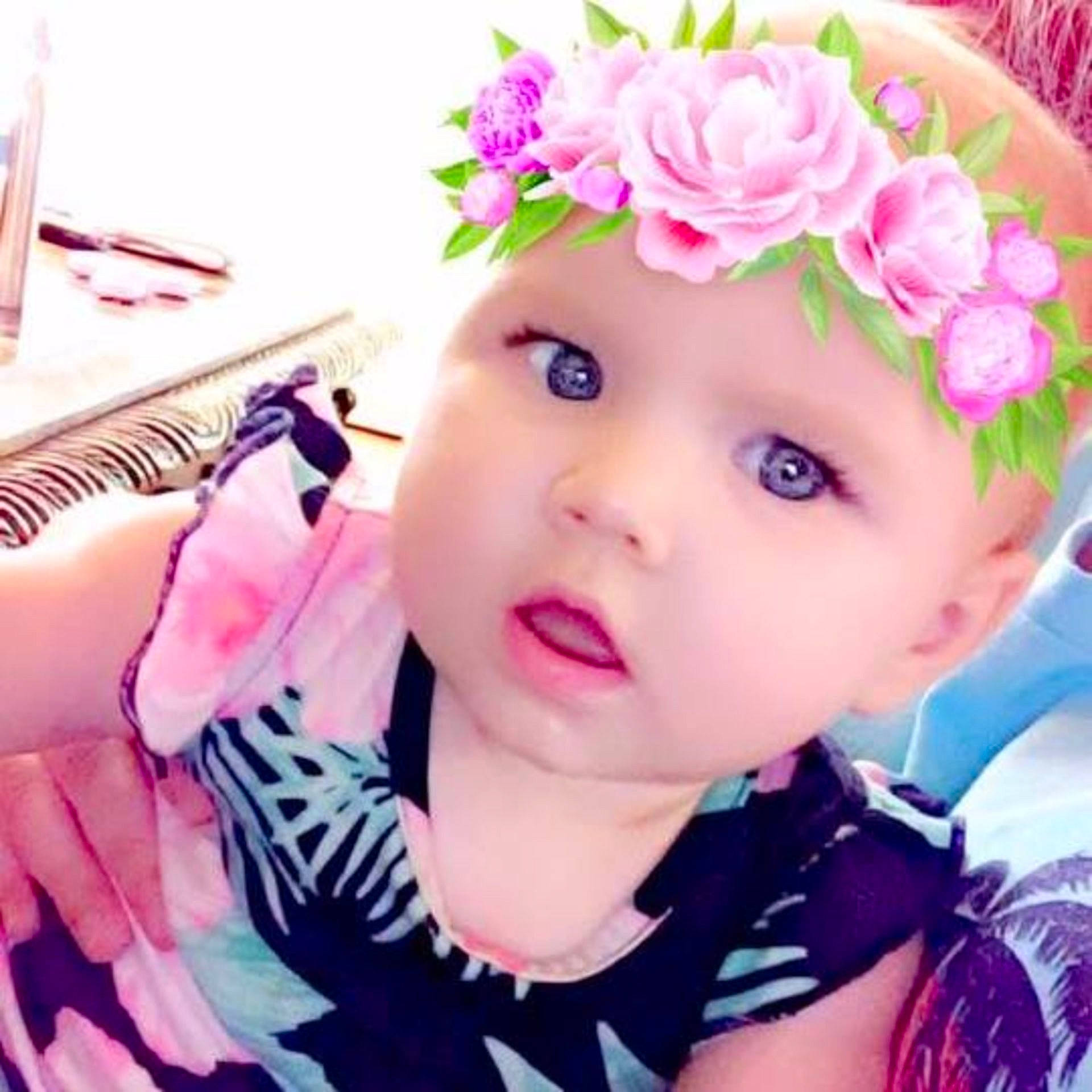 Addisyne is registered to the contest to win money with this photo: cheek, child, child_model, ear, eye, fashion_accessory, flower, girl, hair_accessory, happiness, head, headband, headgear, headpiece, infant, nose, person, pink, product, smile