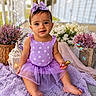 baby, child, purple_dress, bow, polka_dot, sitting, blanket, flowers, bubbles, smile, cute, outdoor, lantern, decor, toddler, portrait, playful, happy, skin, person