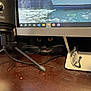 Riki is registered to the contest to win money with this photo: black_cat, cat, whiskers, computer_monitor, desk, microphone, glasses, peeking, eyes, technology, indoor, wooden_surface, cord, shadow, closeup, animal, pet, curious, hidden, workspace