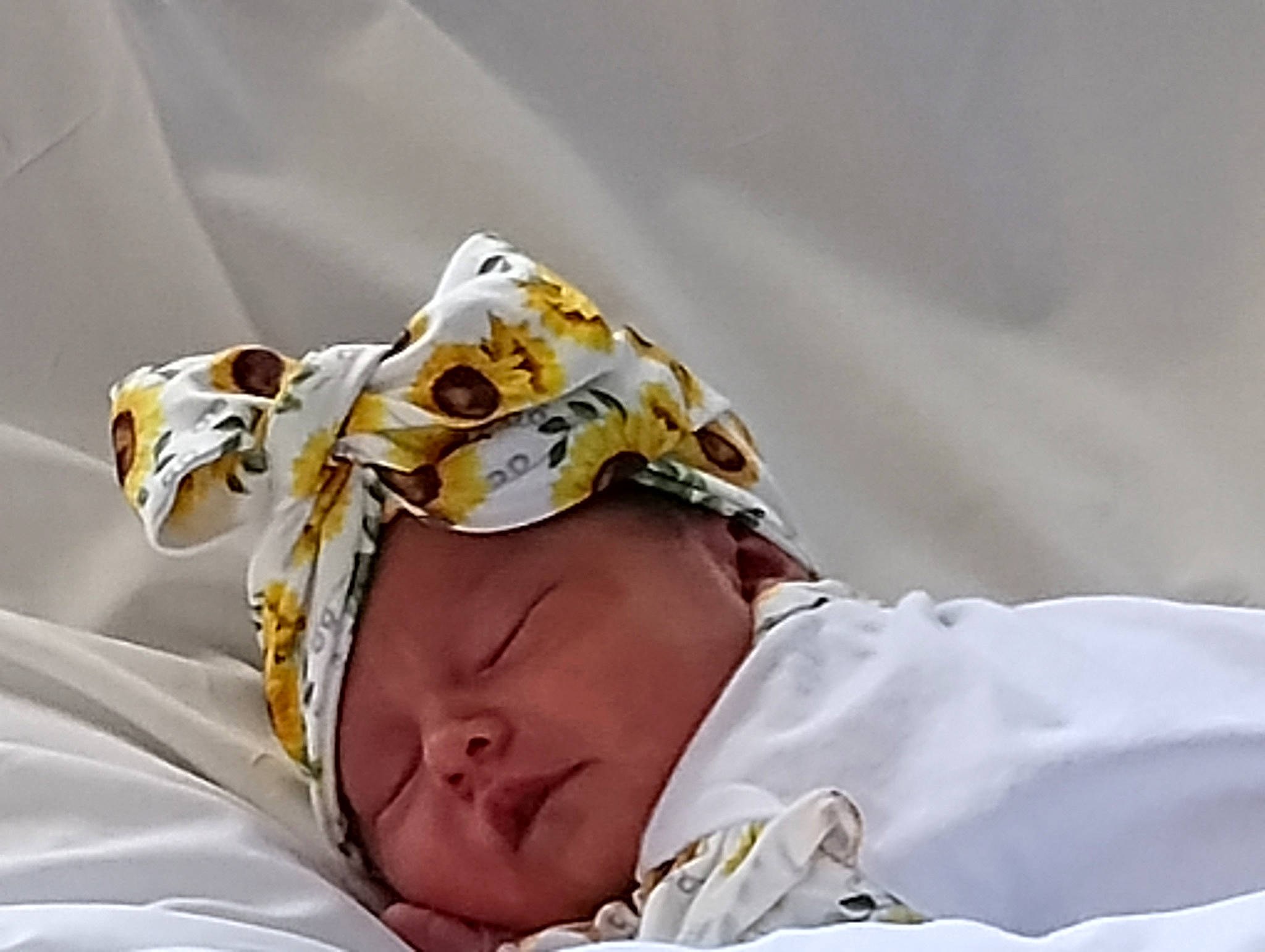 Bria is registered to the contest to win money with this photo: baby, baby_sleeping, bedding, bedtime, comfort, event, eyewear, fashion_accessory, hat, headwear, hospital, linens, medical, medical_equipment, medical_procedure, nap, patient, person, room, service