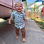Hank joined the competition — help win amazing prizes! toddler, child, barefoot, shirt, dinosaur_pattern, pants, sidewalk, vehicle, van, car, fence, sunflowers, outdoor, daylight, happy, walking, person, smiling, blue_eyes, casual_clothing