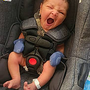 Louis is registered to the contest to win money with this photo: adorable, baby, car_seat, child, cute, fabric, gray, hospital_wristband, indoors, infant, mittens, newborn, person, safety, seat, sleepy, small, strap, yawning, young